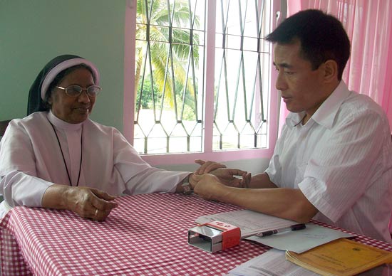 Dr Tara Ngawang Lodoe of Men-Tsee-Khang, Bangalore reading the pulse of a patient during the 4th Tibetan Medical Camp at Renewal Centre, Kochi.