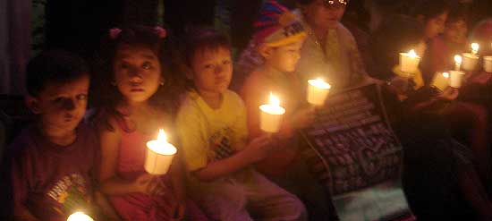 Indian children join Tibetan children during the Candle Light Vigil at Theresa Square on April 17, 2008.