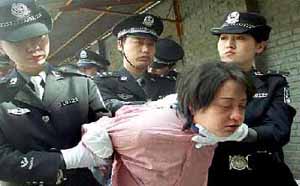 A woman prisoner being taken for her execution after she was sentenced to death at a sentencing rally in Beijing 20 April 2001. Sixteen people were executed in Beijing 20 April, while sentencing rallies and executions were held across the country as part of a nationwide 'strike blackness and wipe out evil' crackdown. (Photo: AFP)