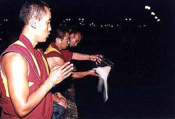Monks pour the remains of Kalachakra Mandala into the sea on March 17, 2000