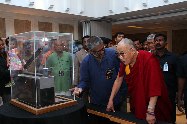 Sethu Das, Founder of Friends of Tibet (India) shows a Zenith radio to His Holiness at the exhibition hall of Tibet artifacts. 'Yes, I remember. I used this radio in Lhasa,' His Holiness replied. His Holiness the XIV Dalai Lama of Tibet was in Kochi to address a gathering of 'Friends of Tibet' members and 'Wellbeing' beneficiaries at the Holiday Inn Cochin on November 25, 2012. His Holiness spoke about 'The Art of Happiness' at a function organised by the 'Friends of Tibet Foundation for the Wellbeing'.