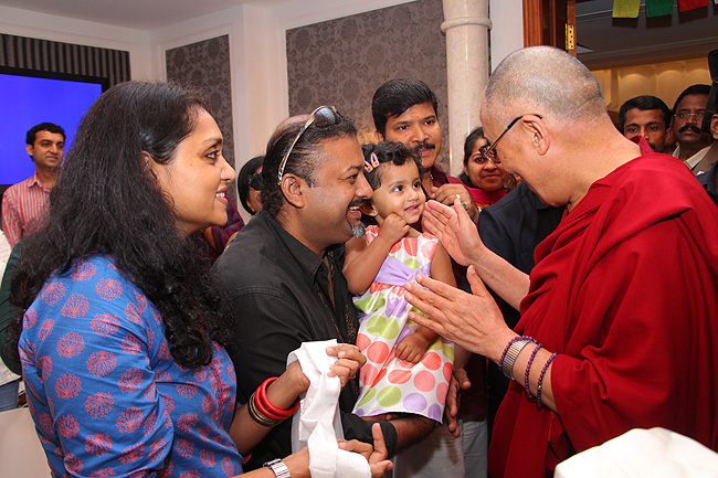 TV Presenter 'Q' seeks blessings of His Holiness the XIV Dalai Lama for his two year old daughter who had the opportunity to get blessed by the Dalai Lama in 2010. His Holiness was in Kochi to address a gathering of 'Friends of Tibet' members and 'Wellbeing' beneficiaries at the Holiday Inn on November 25, 2012. The Dalai Lama spoke about 'The Art of Happiness' at this event organised by the 'Friends of Tibet Foundation for the Wellbeing'.
