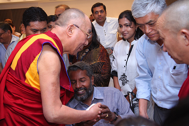 'This day will remain the most memorable day in my life,' says Abba Mohan, who met with a tragic accident some years ago. Abba Mohan, a photographer by profession was one of the hundreds who got blessed by His Holiness the XIV Dalai Lama on November 25, 2012. His Holiness was in Kochi to address a gathering of 'Friends of Tibet' members and 'Wellbeing' beneficiaries at the Holiday Inn on November 25, 2012. The Dalai Lama spoke about 'The Art of Happiness' at this event organised by the 'Friends of Tibet Foundation for the Wellbeing'.