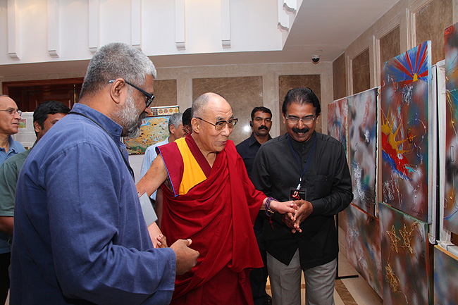 His Holiness the Dalai Lama looks at 'Art of Happiness' painting exhibition by Francis Kodenkandath at the exhibition hall. The artist presented his Tibet painting to the Dalai Lama. His Holiness was in Kochi to address a gathering of 'Friends of Tibet' members and 'Wellbeing' Beneficiaries at the Holiday Inn on November 25, 2012. The Dalai Lama spoke about 'The Art of Happiness' at this event organised by the 'Friends of Tibet Foundation for the Wellbeing'.