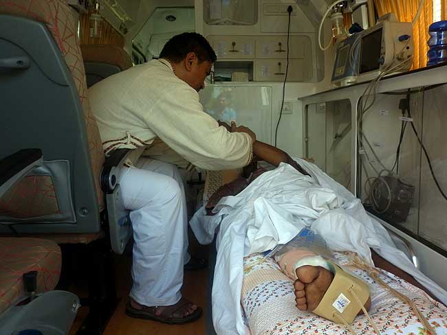 Dr Dorjee Rapten Neshar checks a patient inside an ambulance during the 26th Wellbeing camp organised jointly by Friends of Tibet Foundation for the Wellbeing and Men-Tsee-Khang from Feb 27-Mar 2, 2013. (Photo: Friends of Tibet)