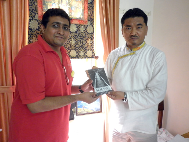 Kochi, Kerala: Eswar Anandan, a Member of Friends of Tibet Foundation for the Wellbeing gives a copy of 'Seasons', his recently-published collection of poems in English to Dr Dorjee Rapten Neshar, Chief Medical Officer of Men-Tsee-Khang Bangalore clinic during the Wellbeing Tibetan Camp at Kochi organised jointly by Friends of Tibet and Men-Tsee-Khang from January 8-11, 2014. (Photo: Friends of Tibet)