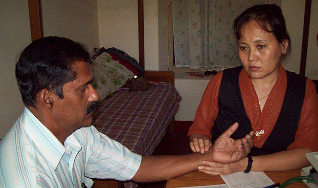 Dr Tamdin Sangmo of Men-Tsee-Khang does a pulse diagnosis with a Wellbeing participant during the 13th Tibetan Medical Camp held at Ashirbhavan, Kacherippadi, Kochi from November 7-8, 2011. (Photo: vj.jose@friendsoftibet.org)