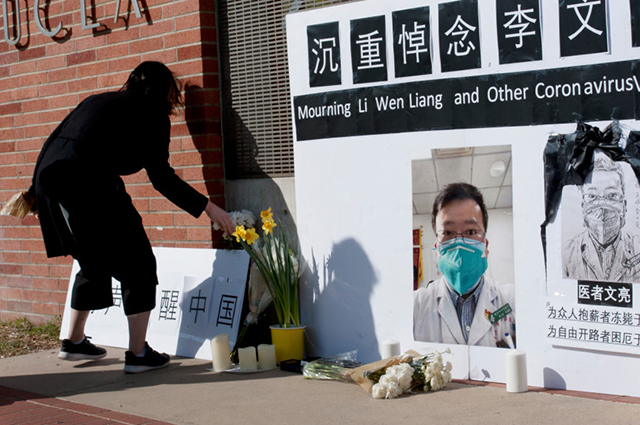 People gather in memory of Dr Li Wenliang, whistleblower Chinese ophthalmologist from the Wuhan Central Hospital on February 15, 2020 (Photo by Ed Crisostomo / Los Angeles Daily News)