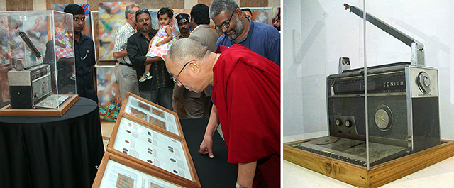 His Holiness the XIV Dalai Lama of Tibet looking at the collection of Friends of Tibet Foundation artefacts in 2012, Sethu Das, founder of Friends of Tibet next to him. 