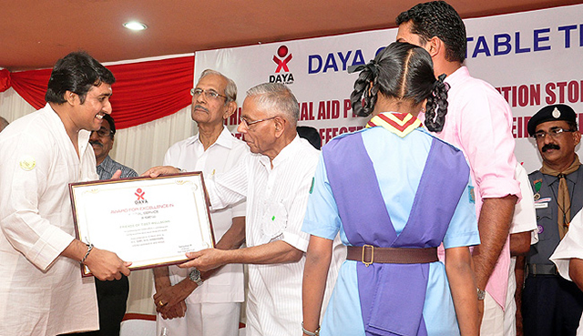 Hon Governor of West Bengal and former National Security Advisor of India, HE Shri MK Narayanan presents 'Award for Excellence in Social Service' to 'Friends of Tibet Foundation' for its 'outstanding and tireless efforts in addressing and raising awareness about social issues and causes' at a function organised by Daya Charitable Trust on March 15, 2014.