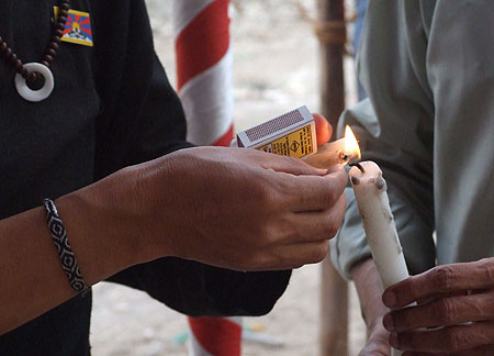 Photograph of Tibetan poet-activist Tenzin Tsundue initiating the Candle Light Vigil in Mumbai on March 10, 2010 to observe 51st Anniversary of the Tibetan National Uprising Day.