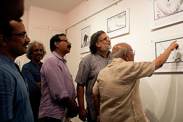 Tushar Gandhi discusses an old Shankar cartoon on Tibet with one of his disciples - Cartoonist Yesudasan. Artist Francis Kodankandath, artist Alexander Devasia, Cartoonist B Unnikrishnan next to them.