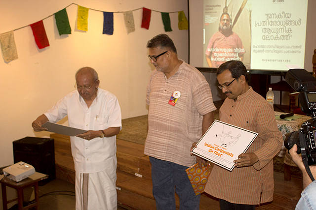 Tushar Gandhi launches 'Indian Cartoonists on Tibet' book project of Friends of Tibet with two political cartoonists from Kerala - Yesudasan and K Unnikrishnan.