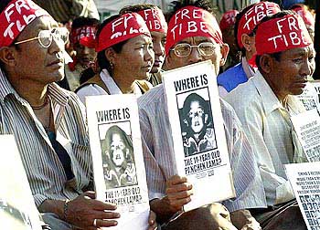 hunger strikers holding photos of young panchen lama