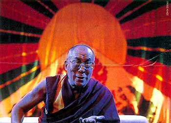 His Holiness the Dalai Lama in front of Tibetan flag