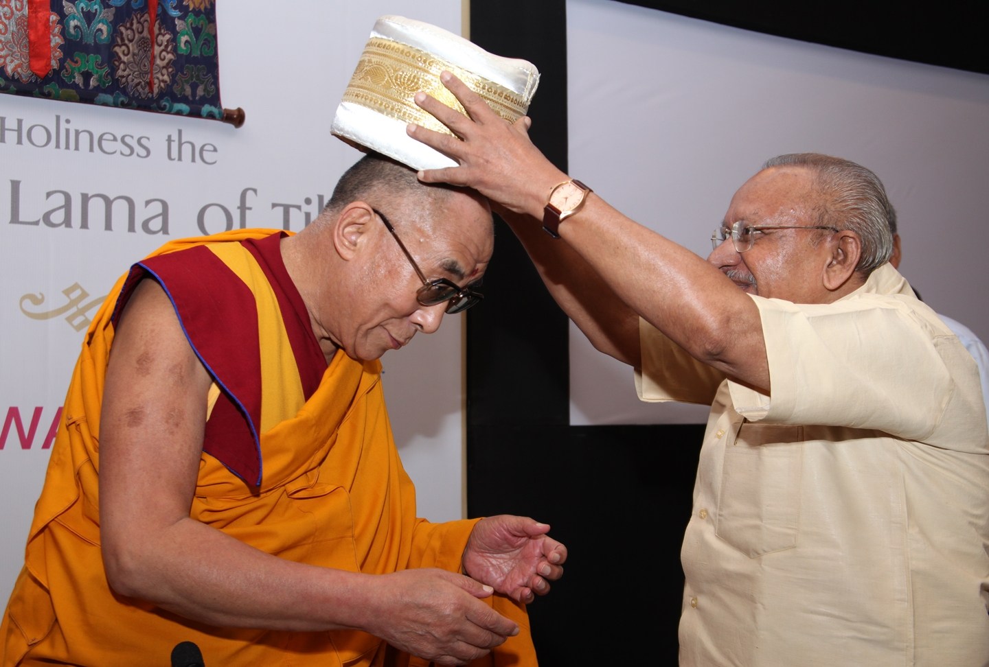 September 04, 2010: Cartoonist Yesudasan presents a 'Kerala Thalappavu' (traditional headgear of Kerala) to His Holiness the XIV Dalai Lama of Tibet during a Friends of Tibet event at The Gateway Hotel of Taj, Kochi, India. (Photo: Ramesh Kumar PS)