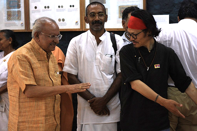 February 11, 2015: Tibetan poet-activist Tenzin Tsundue welcomes Cartoonist Yesudasan during the 'Story of a Nation', an exhibition of antiques, artifacts, and photographs organised by Friends of Tibet in Kerala. (Photo: Prayag Mukundan)