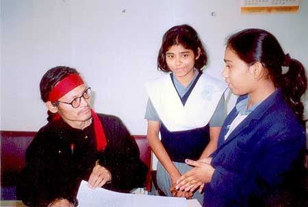 Tenzin Tsundue speaking to two students after his talk at Jugal Devi Saraswati Mandir, Kanpur.