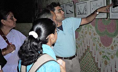 Rohit Singh (Right), a Friends of Tibet Campaigner explains the significance of cartoons to visitors.