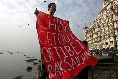 Indian Angle: Shibayan Raha, Campaigns Coordinator of Friends of Tibet unfurls the banner reading: 