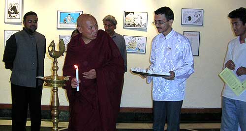 Geshe Lhakdor la, Director of the Tibetan Library and Archives lights a lamp.