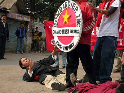 A Tibetan lies down at Mcleod Ganj, Dharamshala and tries to stop the train to Lhasa as a part of a campaign launched by the Students for a Free Tibet and Friends of Tibet on November 03, 2005 protesting against the Golmud Lhasa railway and ask Borbadier, the Canadian coach builder to withdraw from its contract to supply engines and coaches to China Railways. (Photo: Phayul)